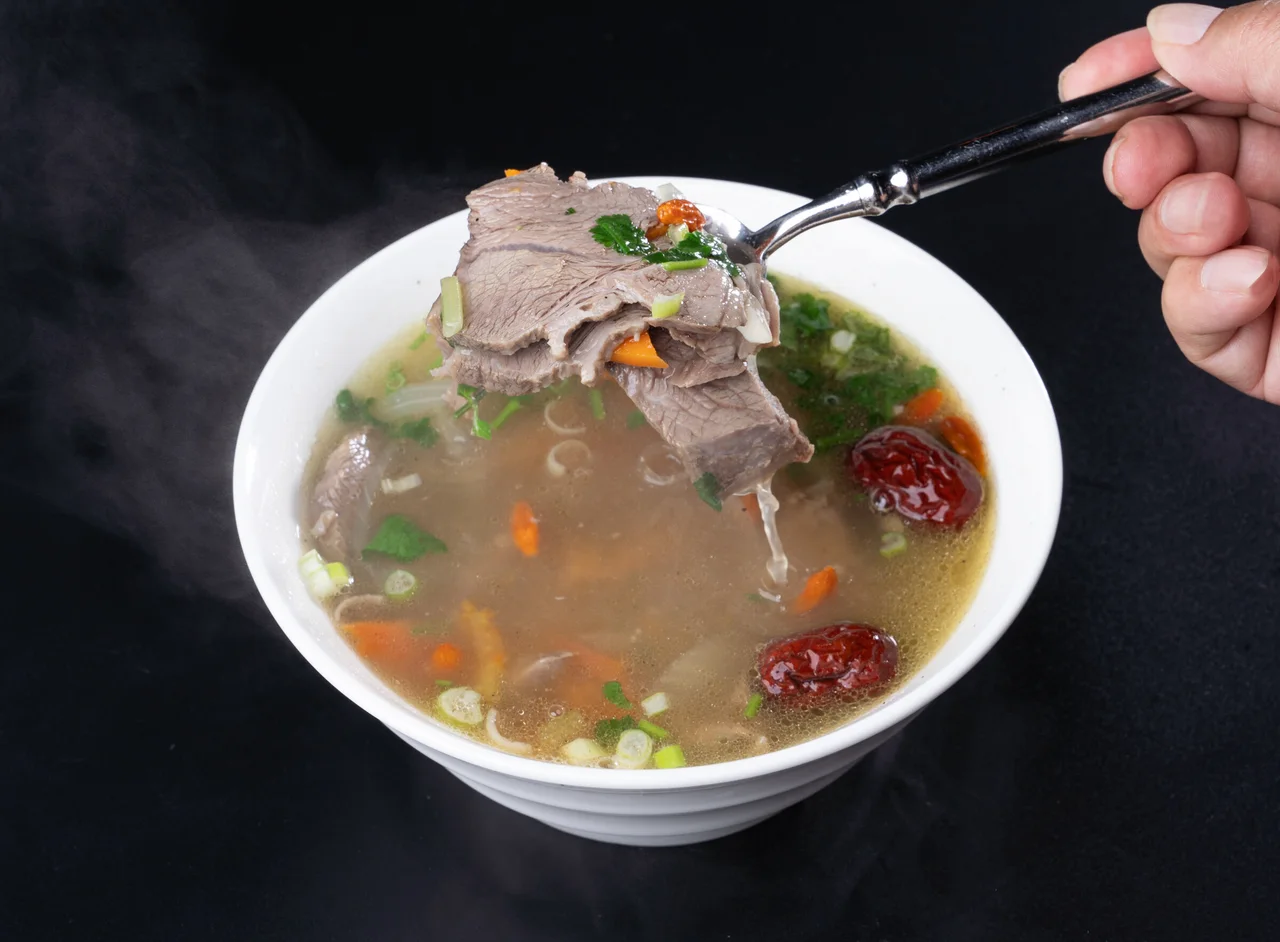 Halal lamb soup — clear broth, slow-simmered at Dolan's